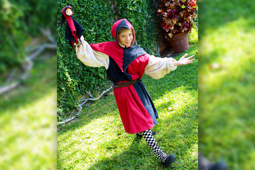 Addy J. as Touchstone, the court jester and quick-witted fool