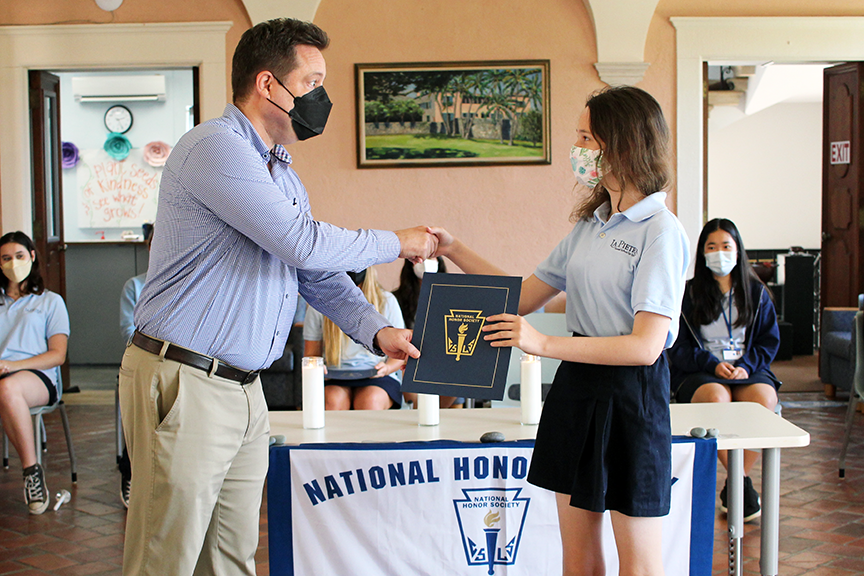 Dr. Watson presents sophomore Melody H. with her NHS certificate.