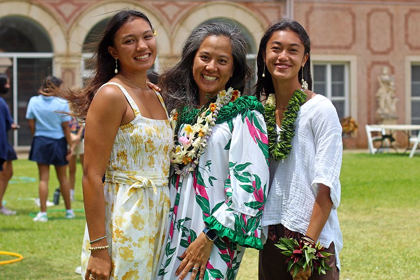 Seniors Gavriella G. (left) and Jazi K. pose with Dr. Alia Pan in their Lei Day best.