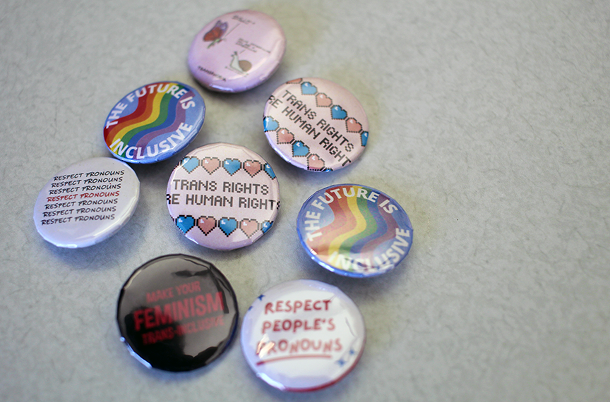 Buttons created and passed out by the Shanti Alliance to promote a campus environment that is welcoming regardless of a person's gender identification and presentation.