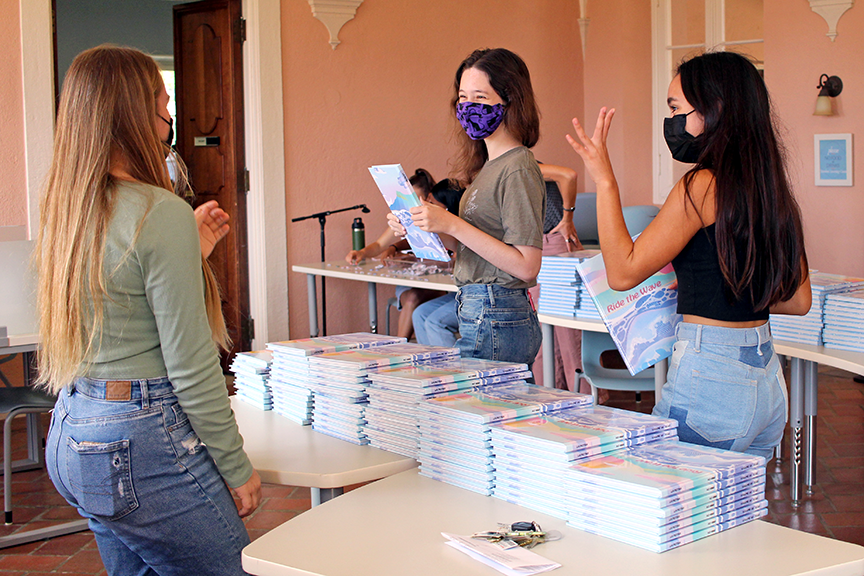 Yearbook staff members pass out books to the student body. 