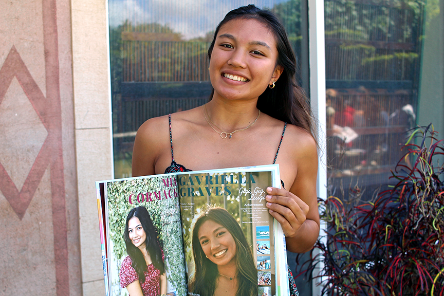 Gavriella G. poses with her senior page in the yearbook.