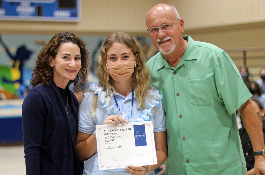 Abigail M. poses with her parents after receiving the Highest Academic Standing award for the freshmen class. Abigail also received the Excellence in Physical Education Award.