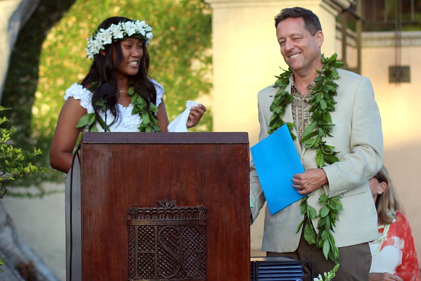 Dr. Watson brings valedictorian Nina B. some tissues during her farewell address.