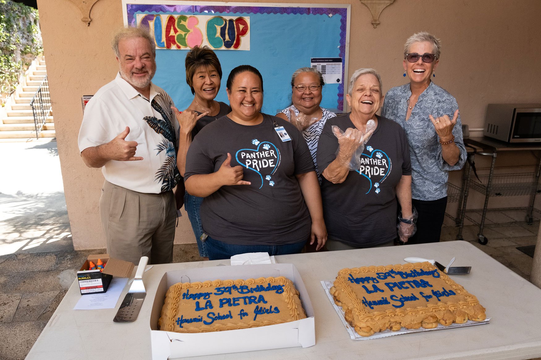 Who's ready for cake?! School trustees, faculty, and staff members get ready to start the celebration.